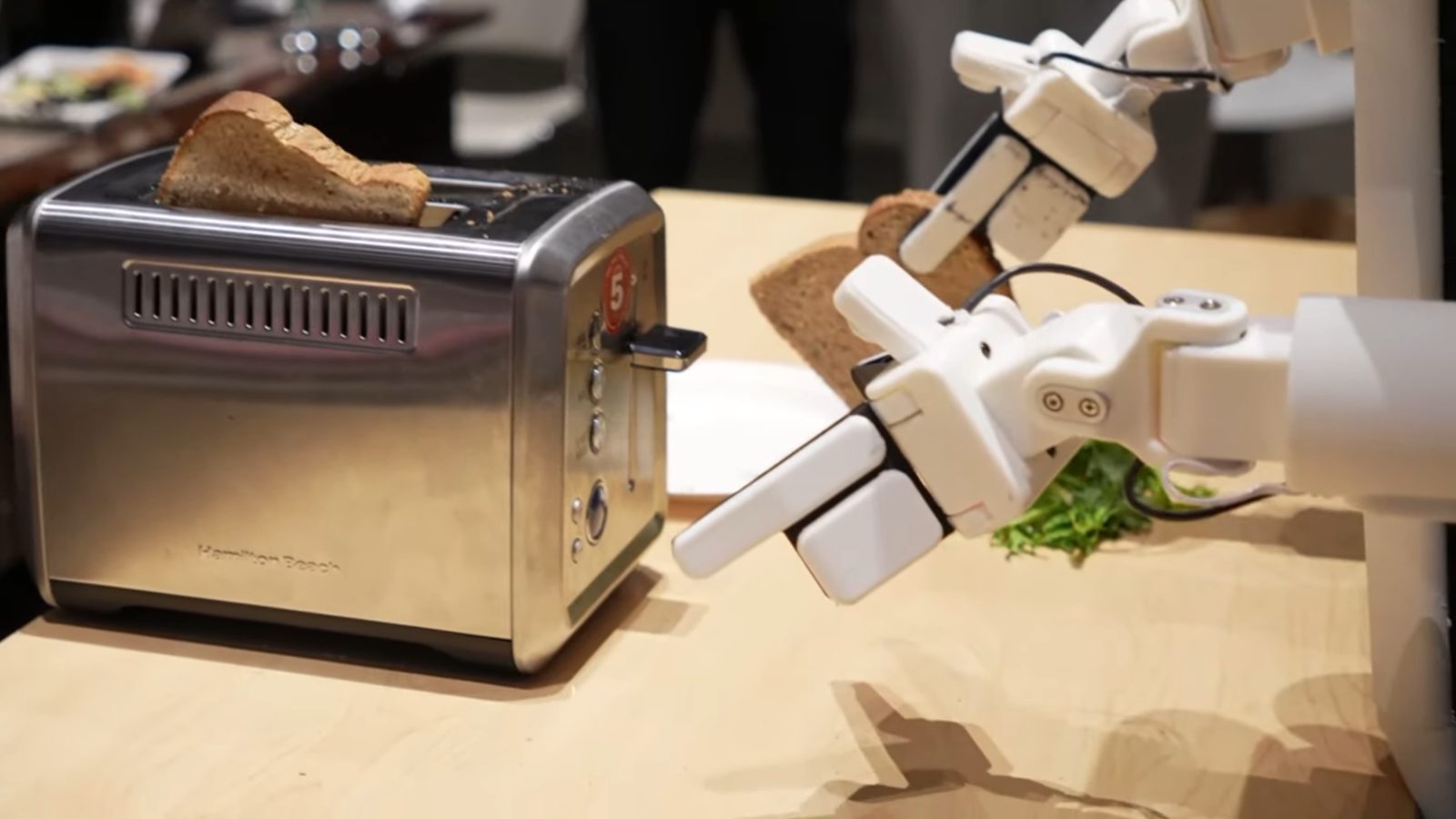 Close-up of the gripper holding a slice of toast