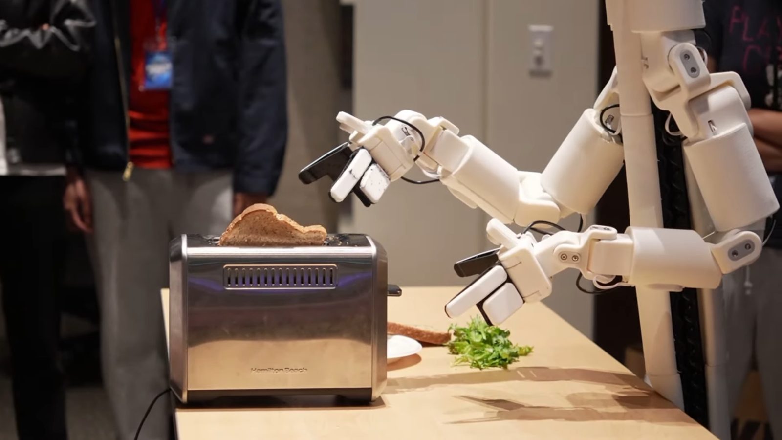 Bracket Bot reaching into the toaster for a slice of toast