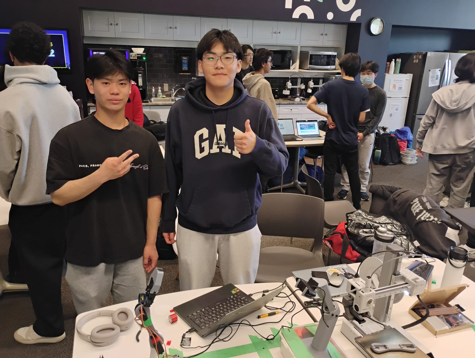 Max and a teammate beside the RICO arm at Eureka Hacks